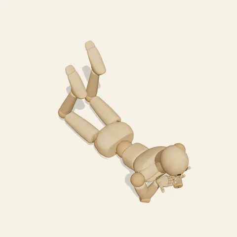 Prone Chin Rest pose reference, high-angle view of a wooden drawing mannequin